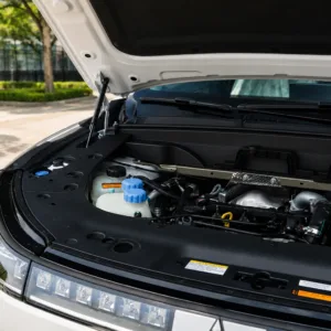 Vehicle engine compartment showing automotive power system details